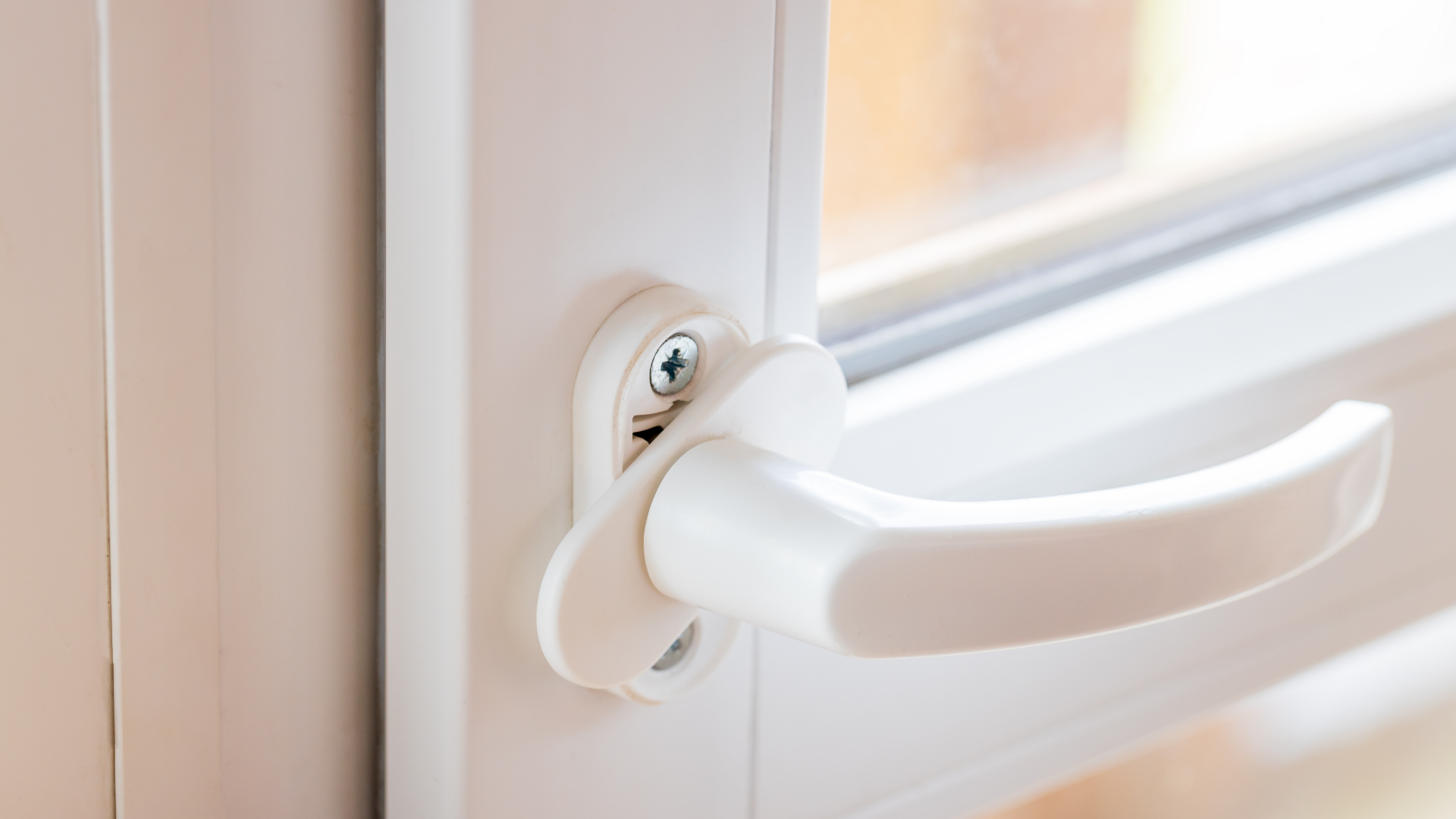 White uPVC door handle and lock being checked during a uPVC door lock repair